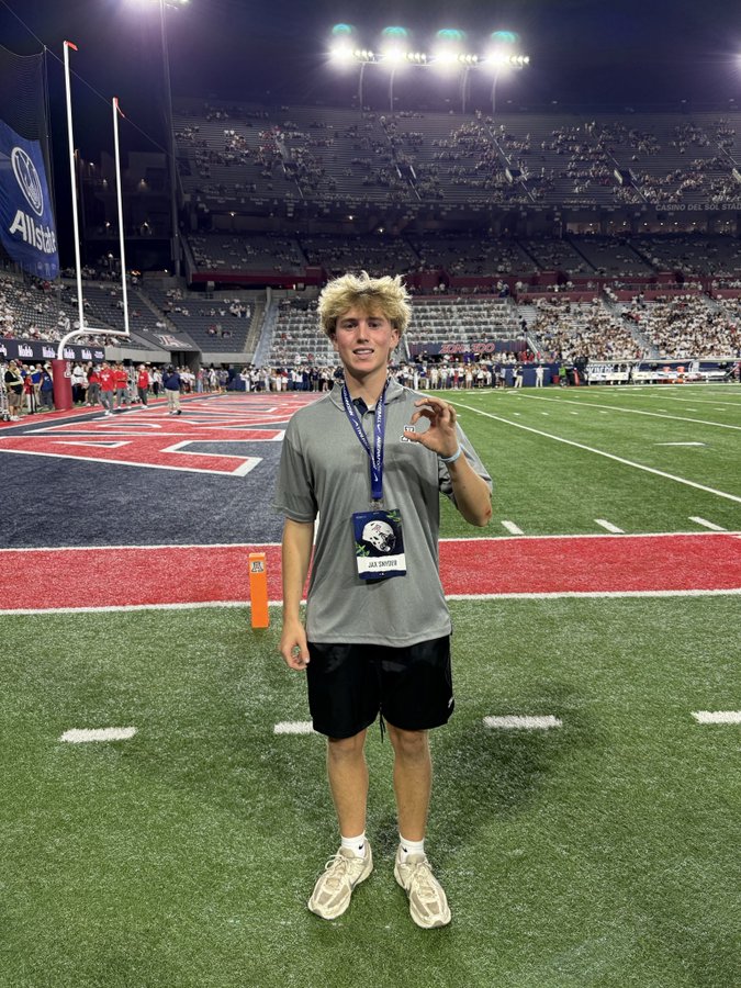 Jax Snyder on the field at Arizona Stadium with his game day visit credential